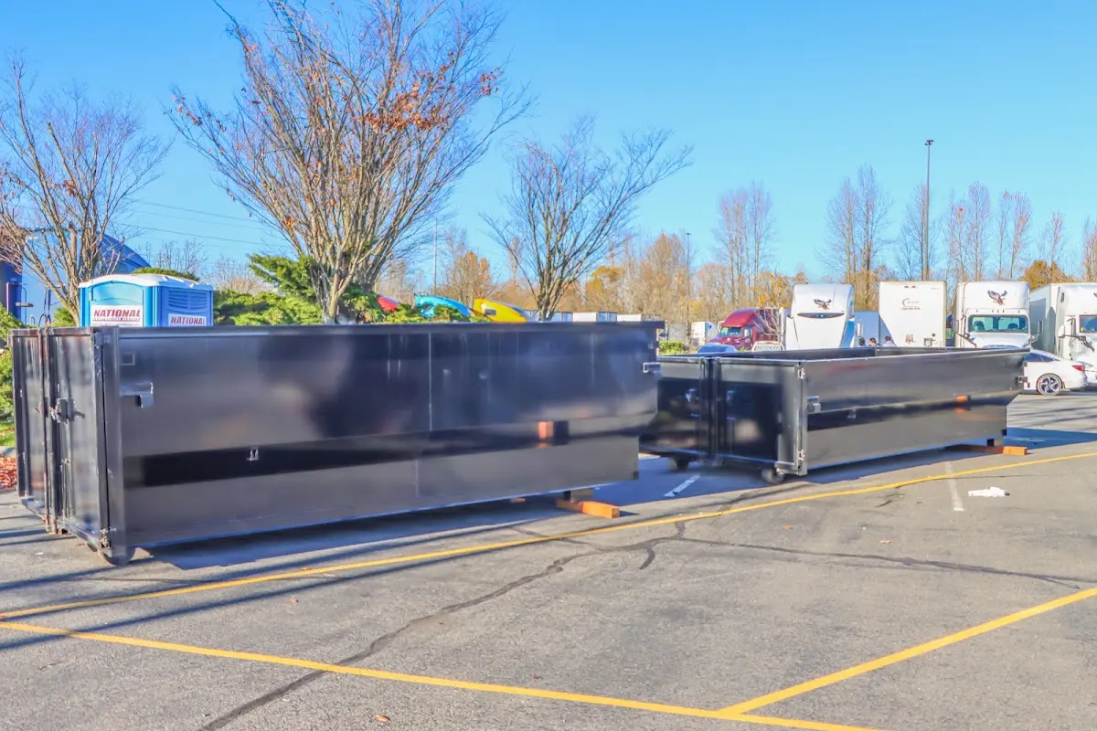 Professional dumpster rental service with roll-off container on residential driveway in Folcroft